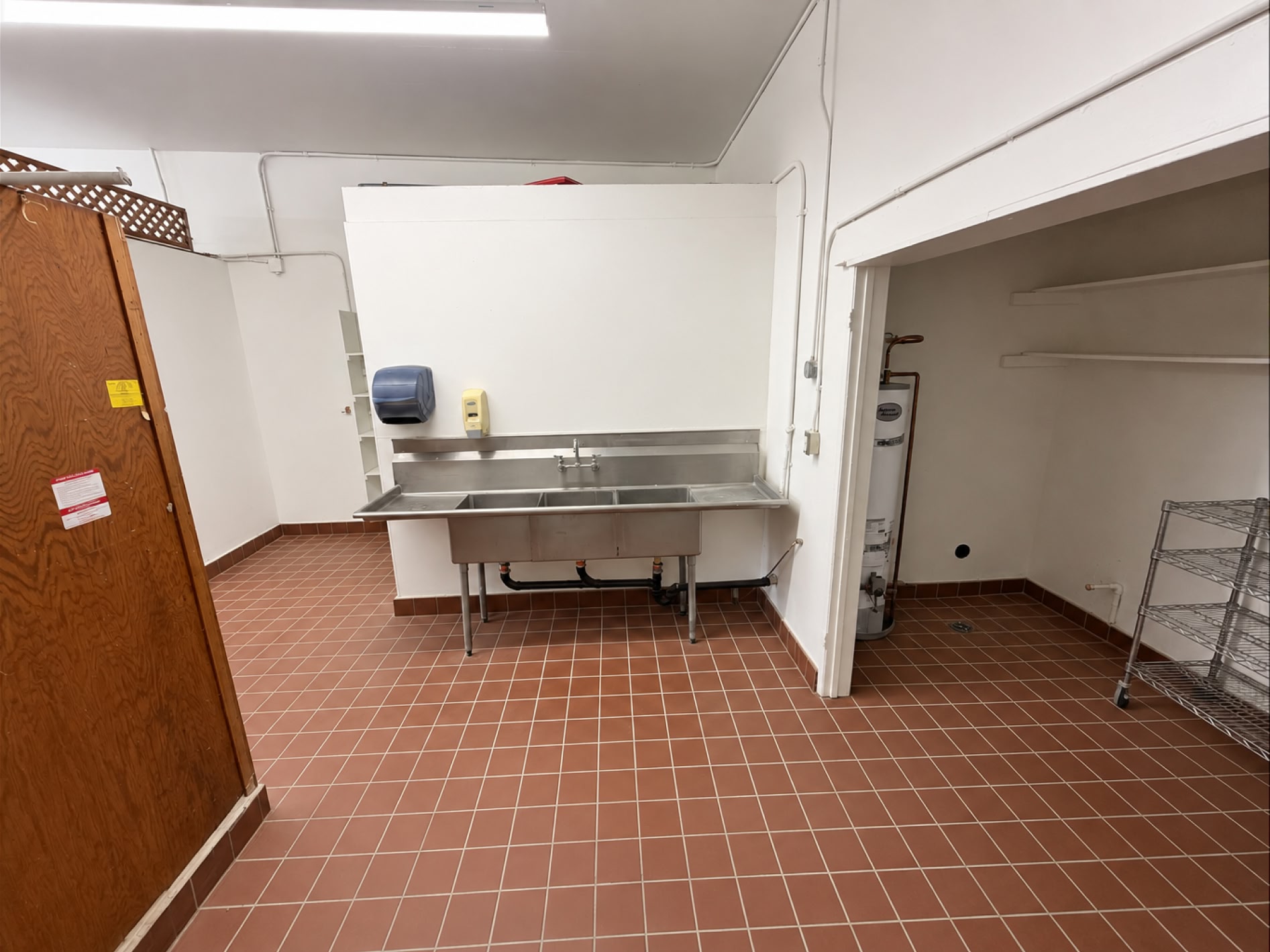 Utility area with stainless sink and water heater