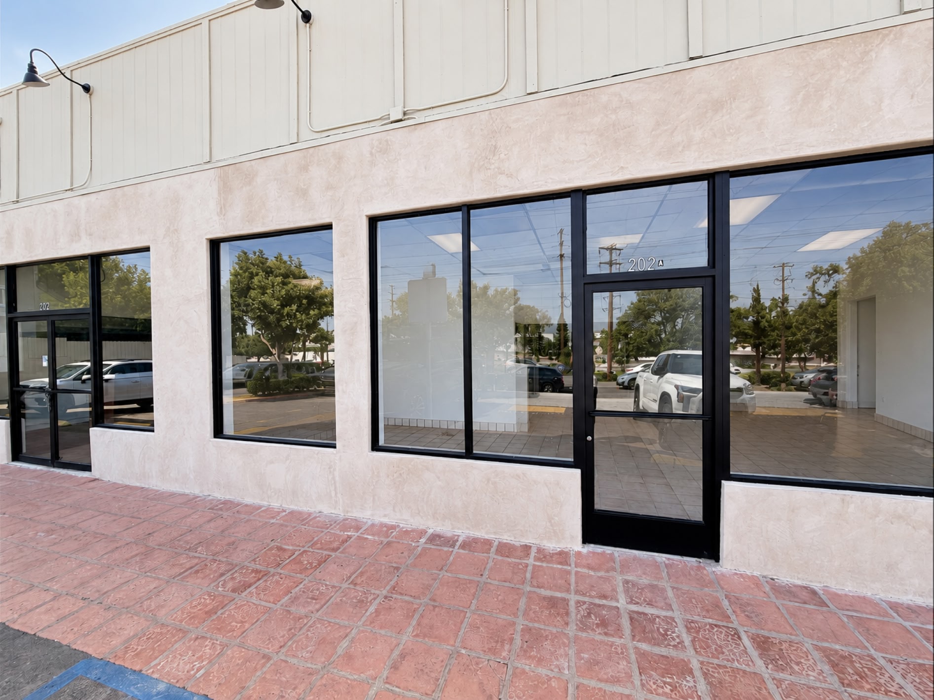 Corner exterior of 200 Imperial Ave with black-framed storefront windows